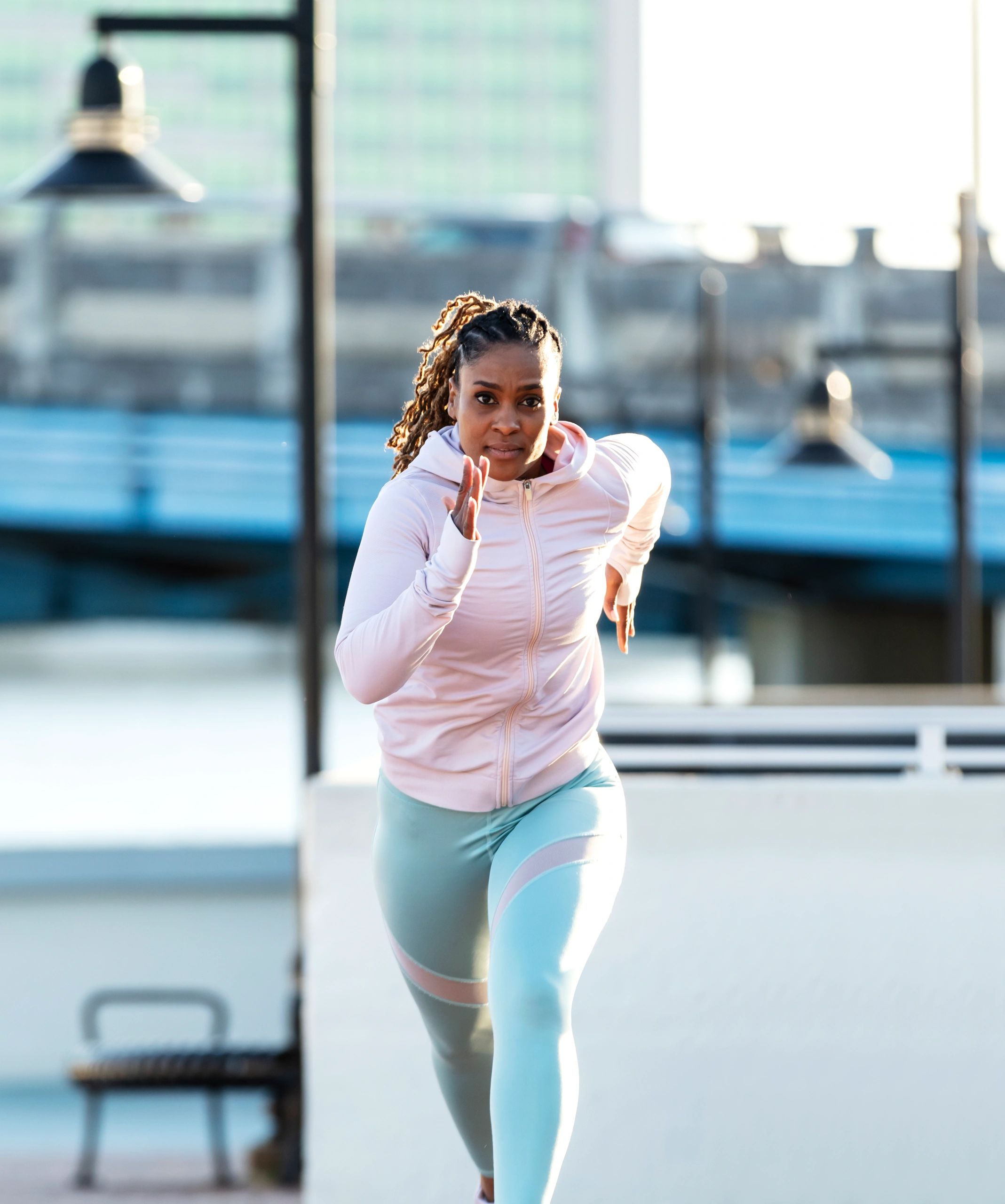 Woman in workout attire sprinting, representing the Fashion style option